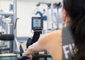 This is a picture of a woman working out on a Concept2 Rowing Machine